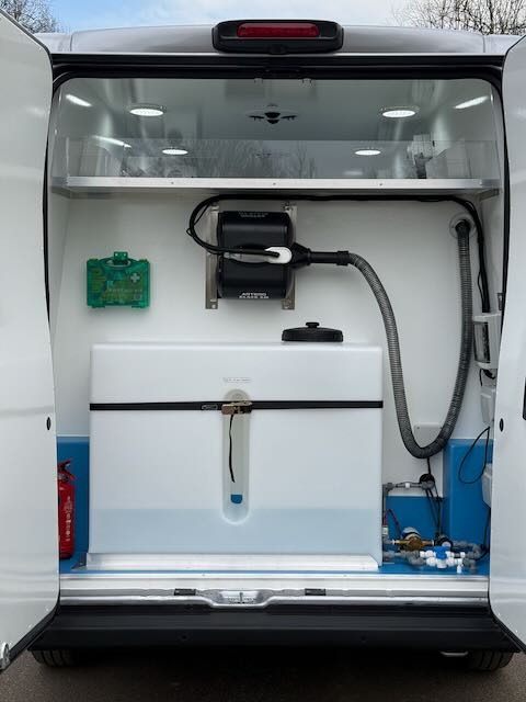 Rear of the van with the on-board water tank and dryer