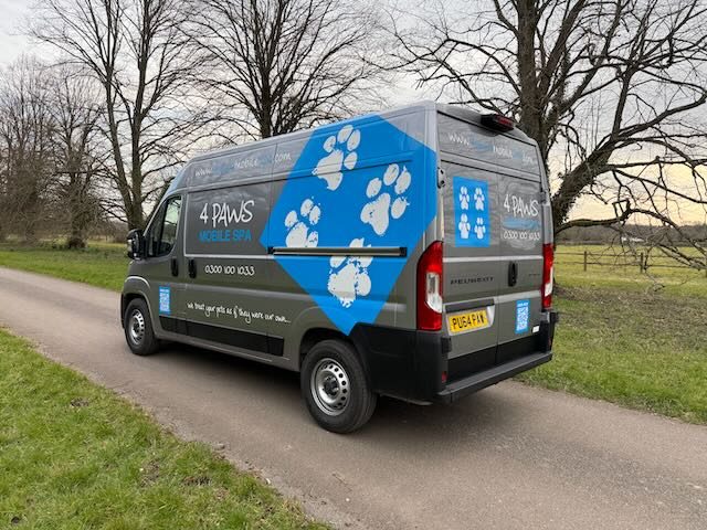 Side view of one of our latest silver 4 Paws Mobile Spa vans with blue paw-print livery
